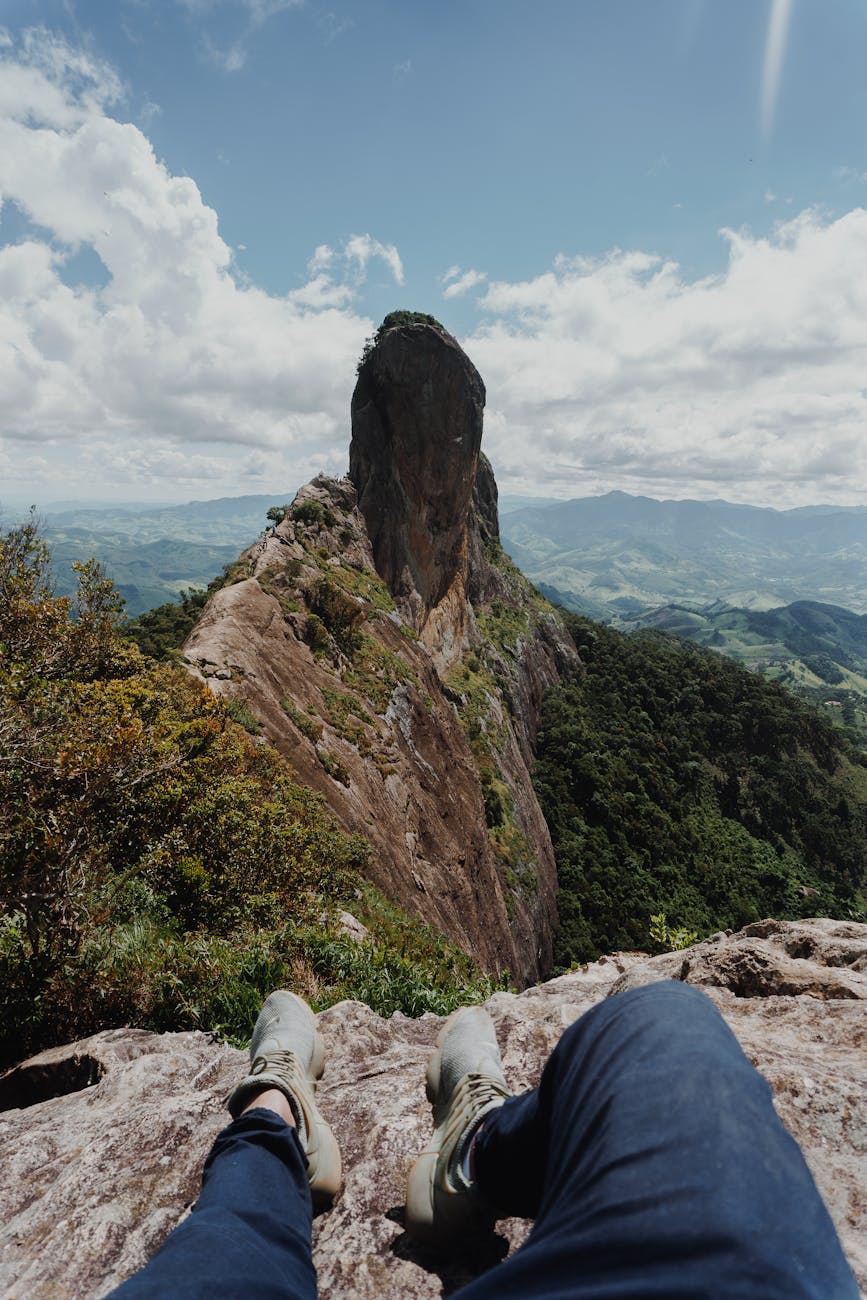 Person Sitting on Gray Rock Formation